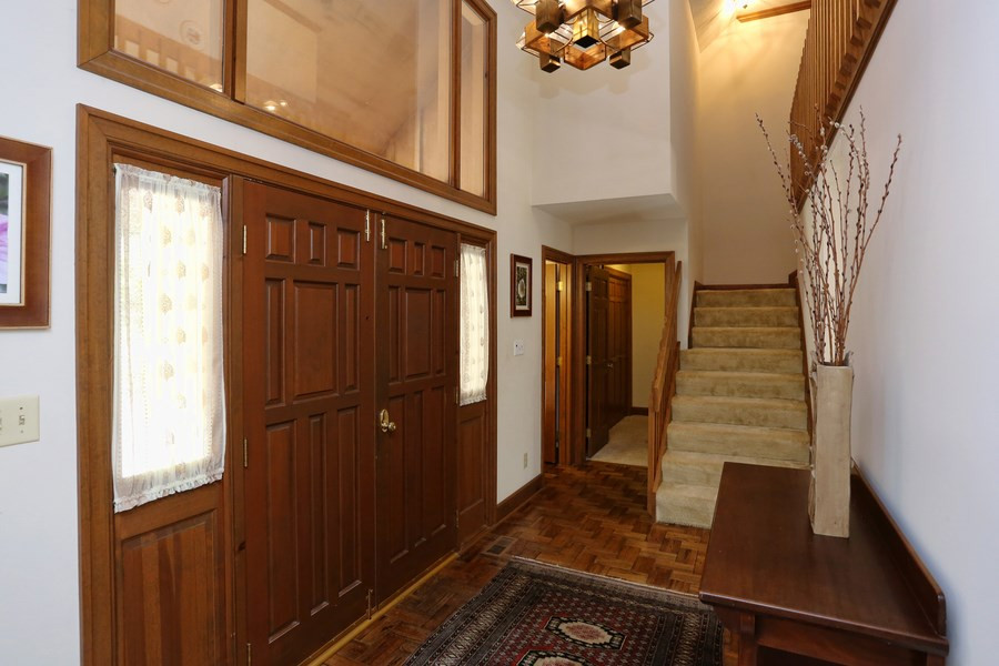 10420 Whitestone Road Raleigh, NC 27615 - Photo 3 of 24 Two solid wood doors opens to foyer with vaulted ceiling and parquet flooring. Fabulous Foyer!