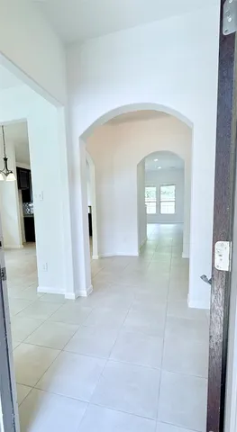 an empty room with windows and cabinet