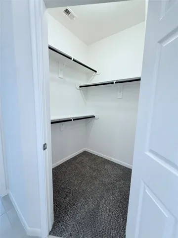 a large kitchen with a stove a refrigerator and a sink