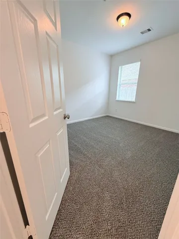 a view of a kitchen with a sink and a large window