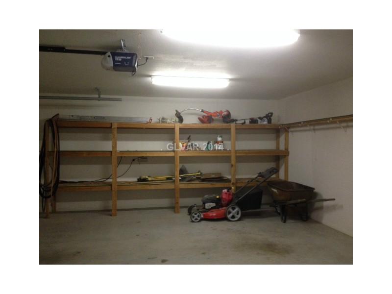 381 Big Five Road Pahrump, NV 89048 - Photo 23 of 35 Parking Lot. Storage Shelves in Garage.Lawn equipment stays