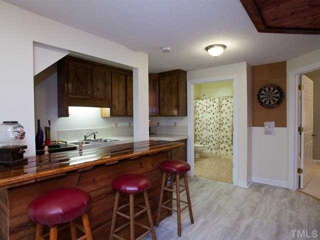 1929 Partridge Berry Drive Raleigh, NC 27606 - Photo 22 of 25 Journey downstairs to the finished basement and you'll find another den with a wet bar...the perfect space for entertaining! There is also a full bath. Basement