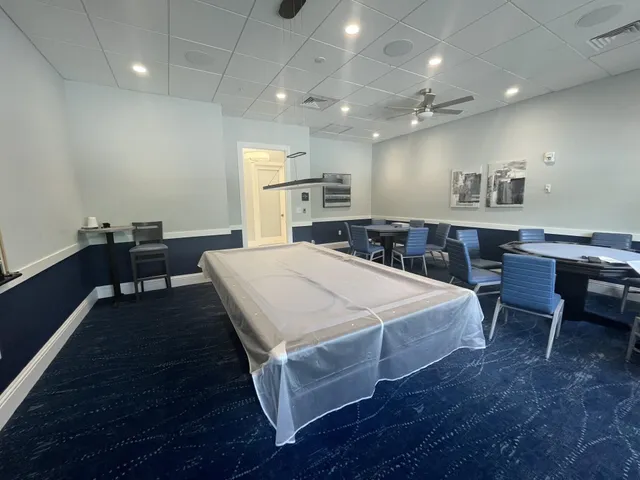 a large kitchen with kitchen island a sink table and chairs