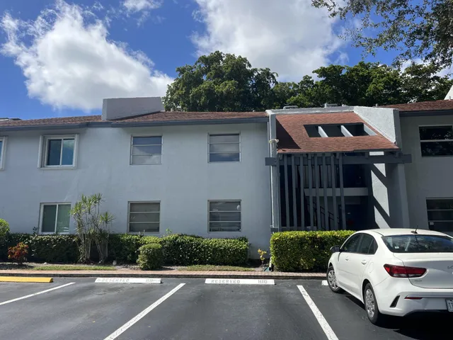 a front view of a house with a yard and a garage