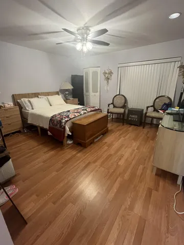 a spacious bedroom with a bed and a dresser