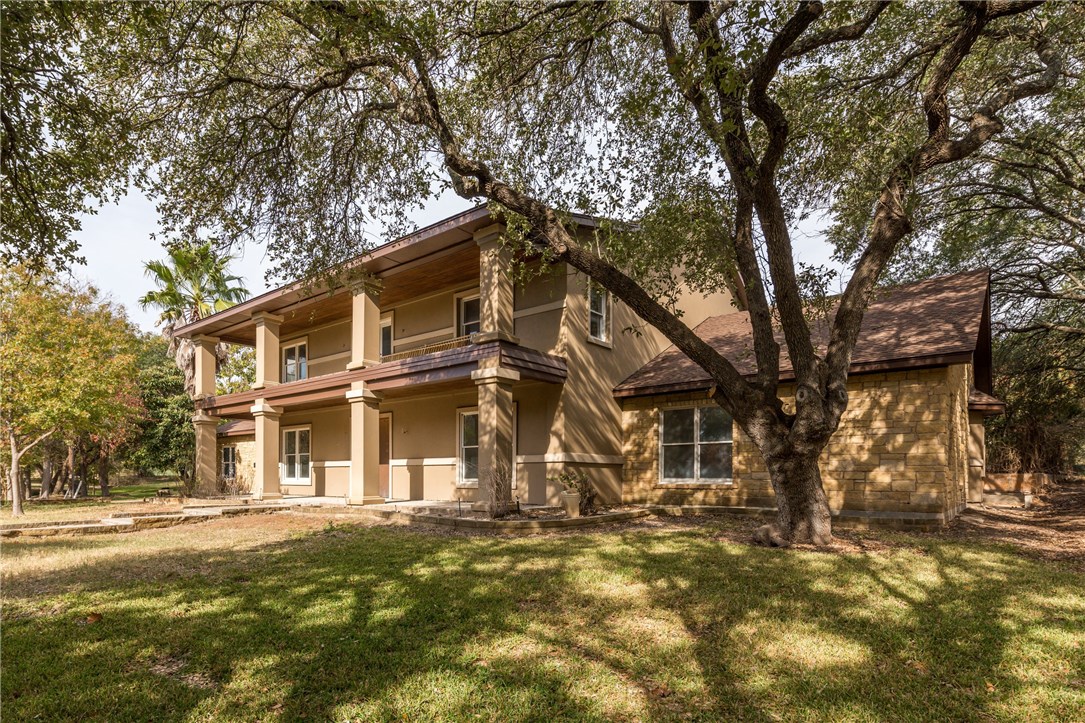 a view of a large building with large trees