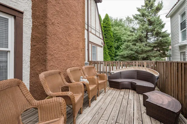 a roof deck with couches and wooden floor