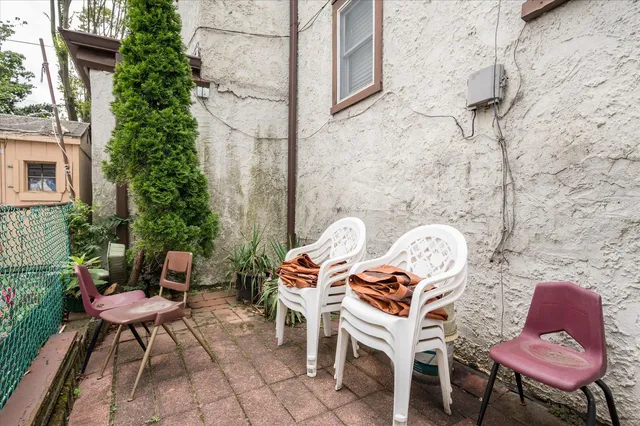 a backyard of a house with table and chairs