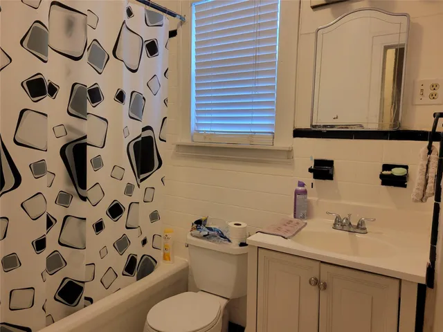 a bathroom with a sink and mirror with toilet