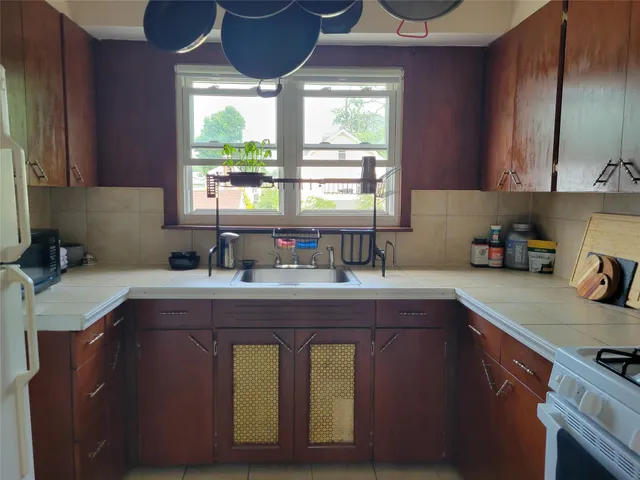 a kitchen with a sink cabinets and window