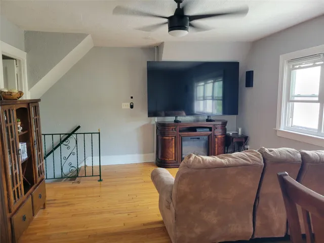 a living room with furniture window and wooden floor