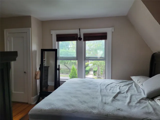 a bedroom with a large bed and a large window