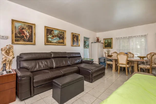 a living room with furniture dining table and a couch