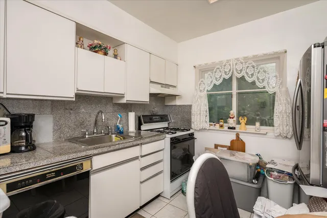 a kitchen with a sink stove and cabinets