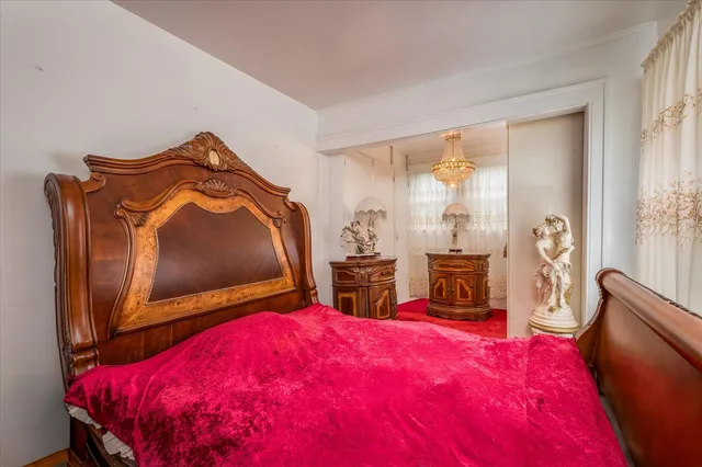 a bed room with a bed and a mirror