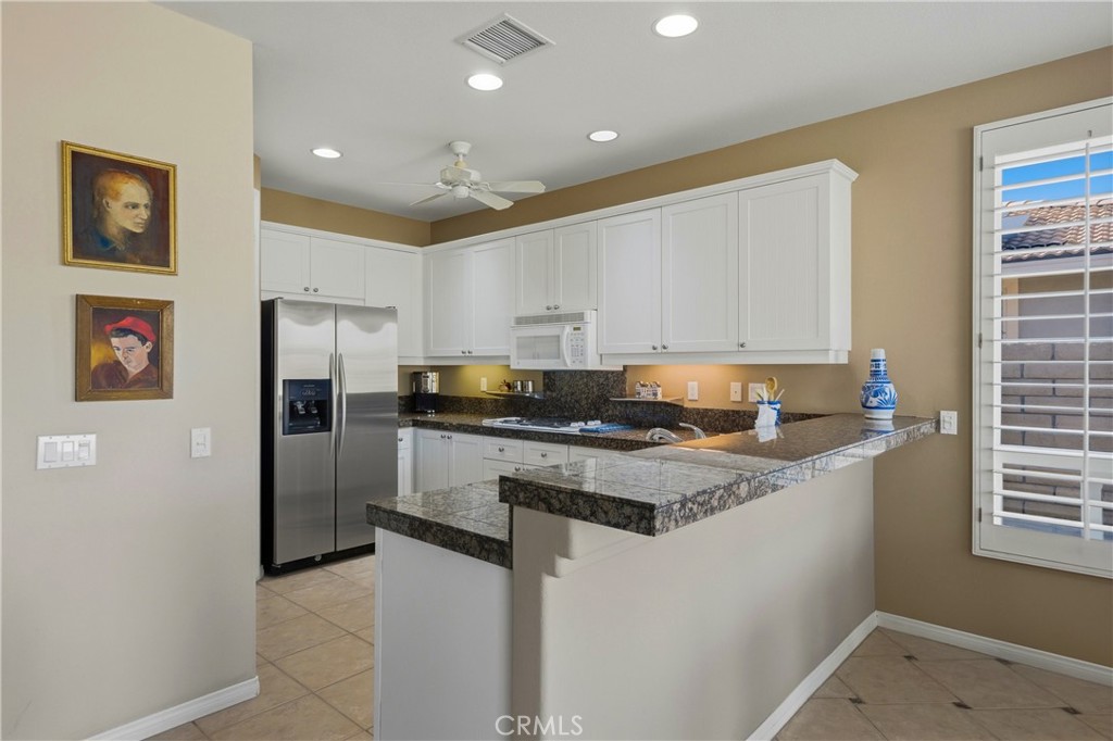 241 Via Martelli Rancho Mirage, CA 92270 - Photo 13 of 37 a kitchen with stainless steel appliances granite countertop a stove a refrigerator and a sink