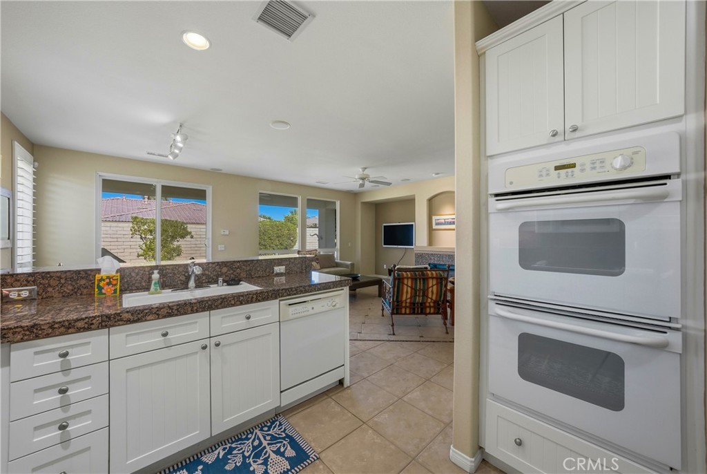 241 Via Martelli Rancho Mirage, CA 92270 - Photo 14 of 37 a kitchen with a sink and cabinets