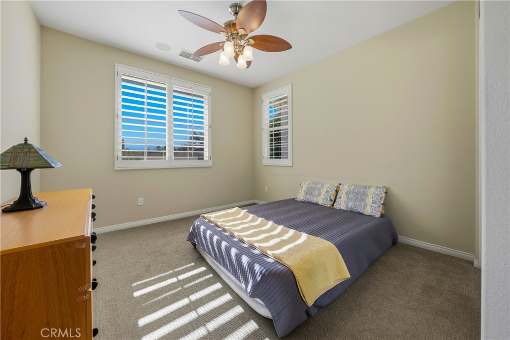 241 Via Martelli Rancho Mirage, CA 92270 - Photo 16 of 37 a bedroom with a bed and a chandelier