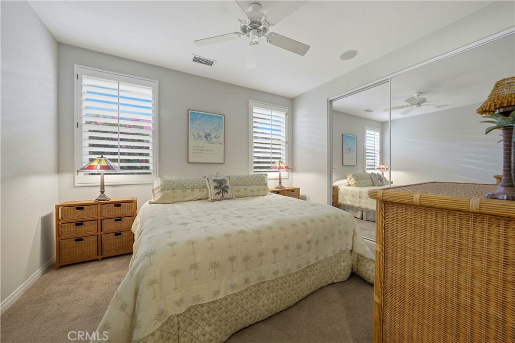 241 Via Martelli Rancho Mirage, CA 92270 - Photo 18 of 37 a bedroom with a bed and dresser with mirror
