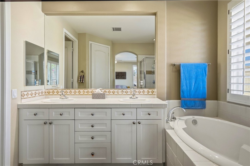 241 Via Martelli Rancho Mirage, CA 92270 - Photo 23 of 37 a bathroom with a tub sink and mirror