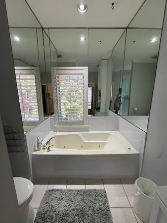 a bedroom with bed window and a ceiling fan