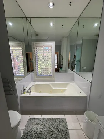 a bedroom with bed window and a ceiling fan