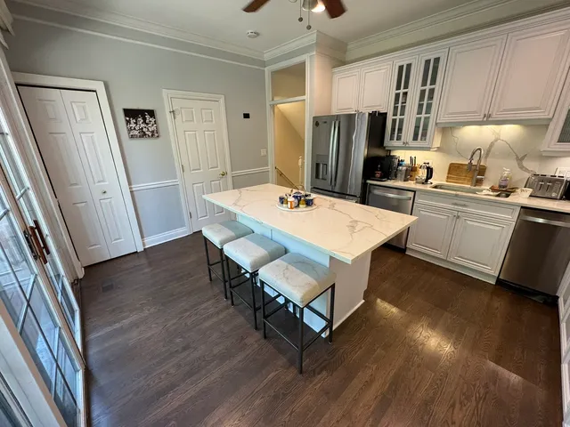 a kitchen with kitchen island sink stove and cabinets