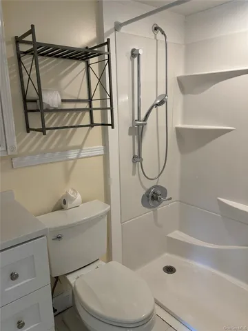 a bathroom with a toilet and a shower