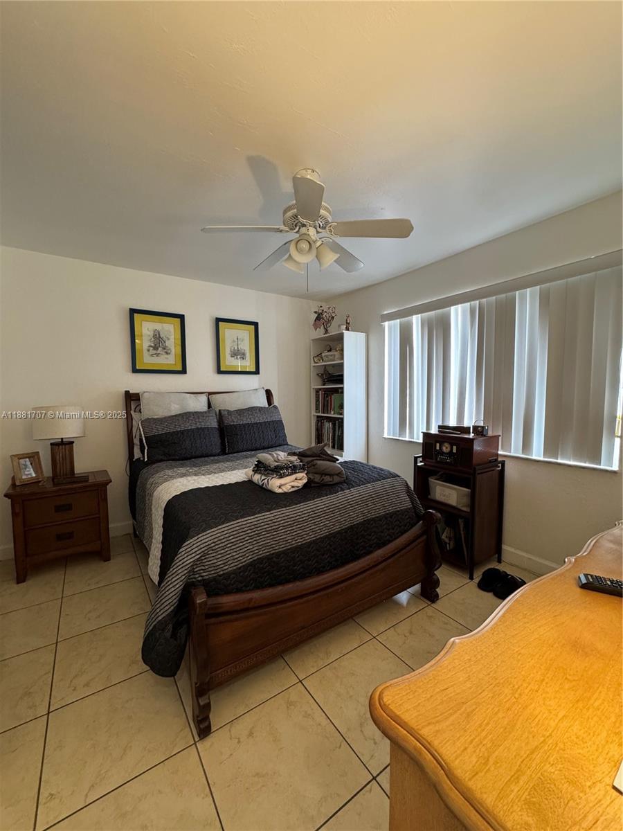 15480 Southwest 82nd Lane, Unit 228 Miami, FL 33193 - Photo 14 of 18 a bedroom with a bed and a dresser next to a window