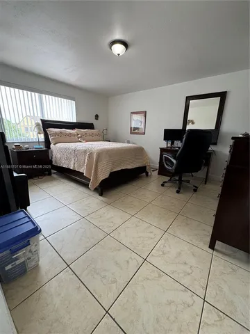 a bedroom with a bed and a desk