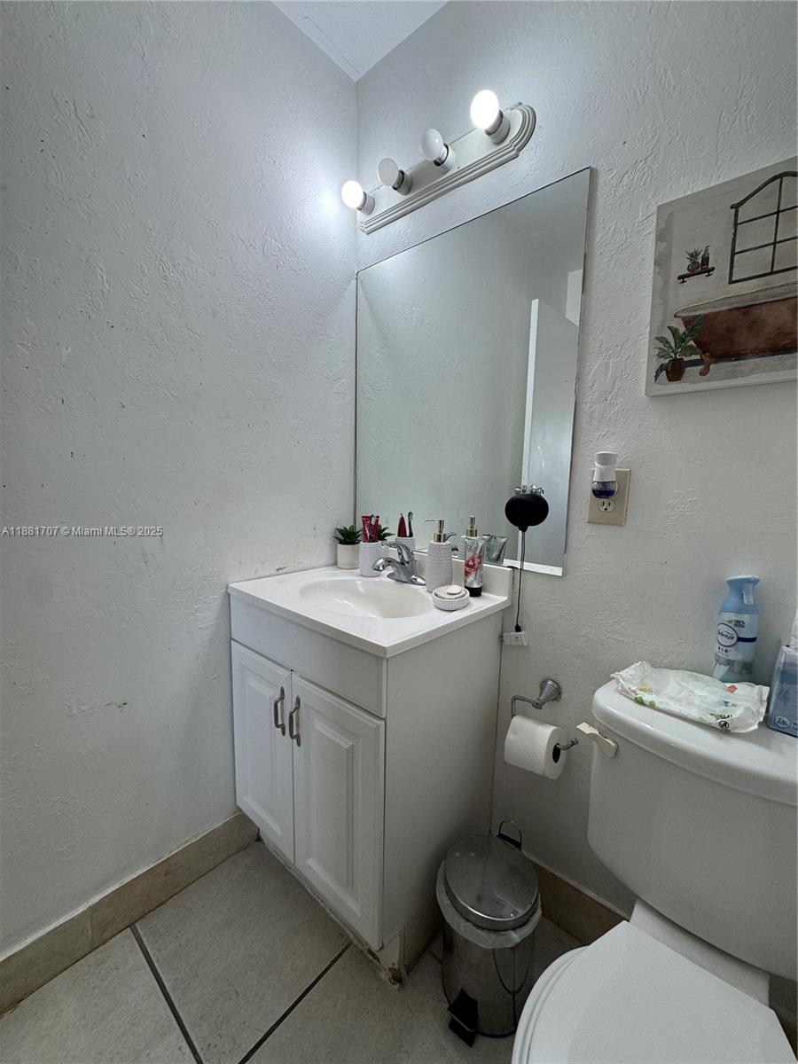 15480 Southwest 82nd Lane, Unit 228 Miami, FL 33193 - Photo 18 of 18 a bathroom with a toilet sink and mirror
