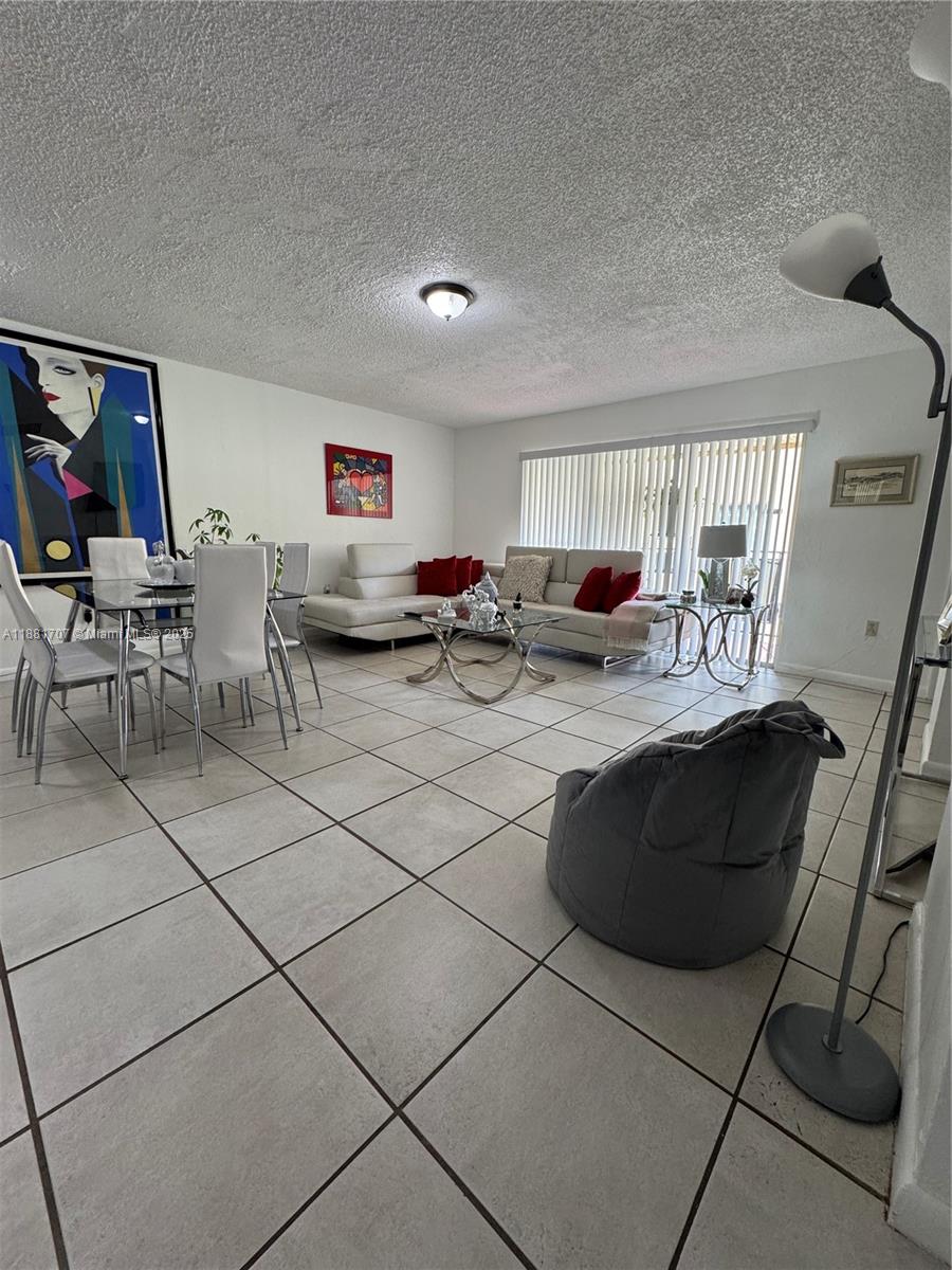 15480 Southwest 82nd Lane, Unit 228 Miami, FL 33193 - Photo 3 of 18 a living room with furniture and a window