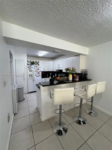 a kitchen with a sink cabinets and window