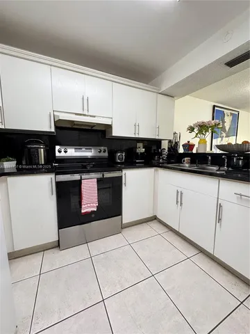 a kitchen with stainless steel appliances granite countertop a sink and cabinets