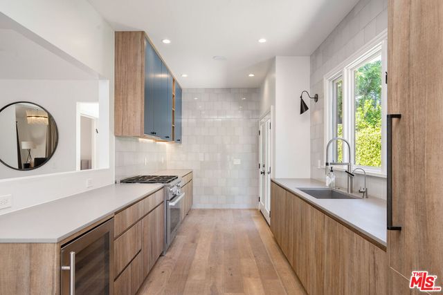 a kitchen with a sink stove and cabinets