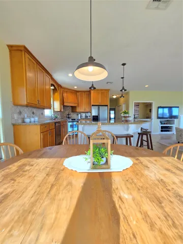 a view of a kitchen with kitchen island dining table and chairs