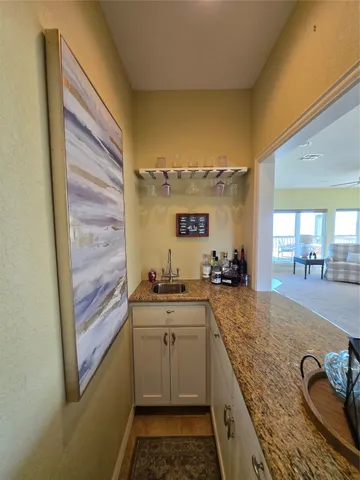 a kitchen with granite countertop a sink and cabinets