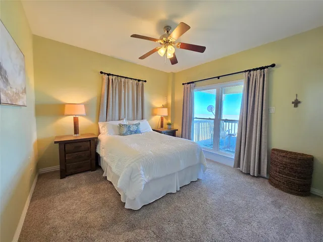 a spacious bedroom with a bed and a chandelier