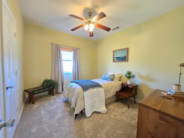 a bed room with a bed and a chandelier