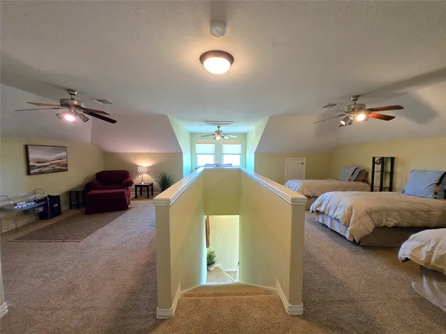 a spacious bedroom with a bed and a chandelier