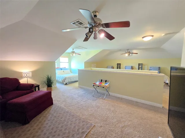 a bed room with furniture and a ceiling fan
