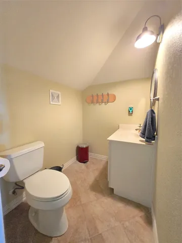 a bathroom with a toilet and a mirror