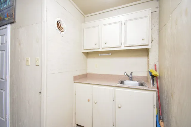 a bathroom with a sink and cabinets