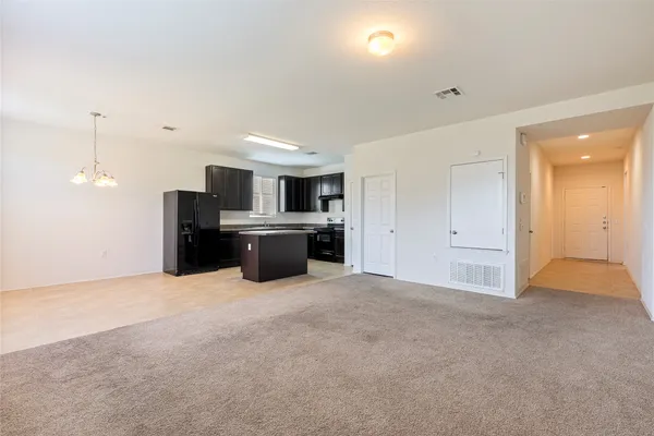 a view of a backyard with wooden fence
