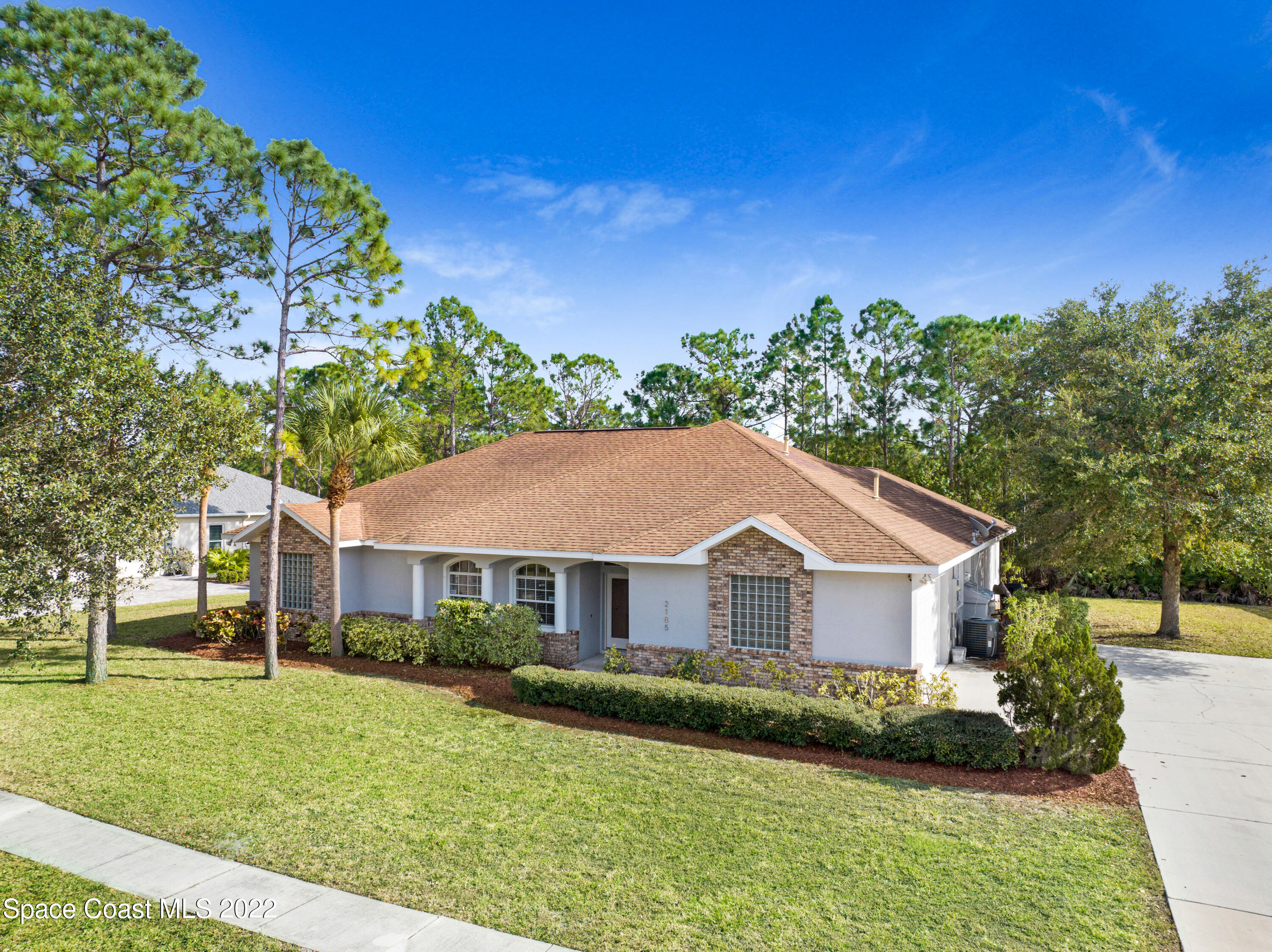2185 Windbrook Drive Palm Bay, FL 32909 - Photo 1 of 61 a front view of a house with a yard