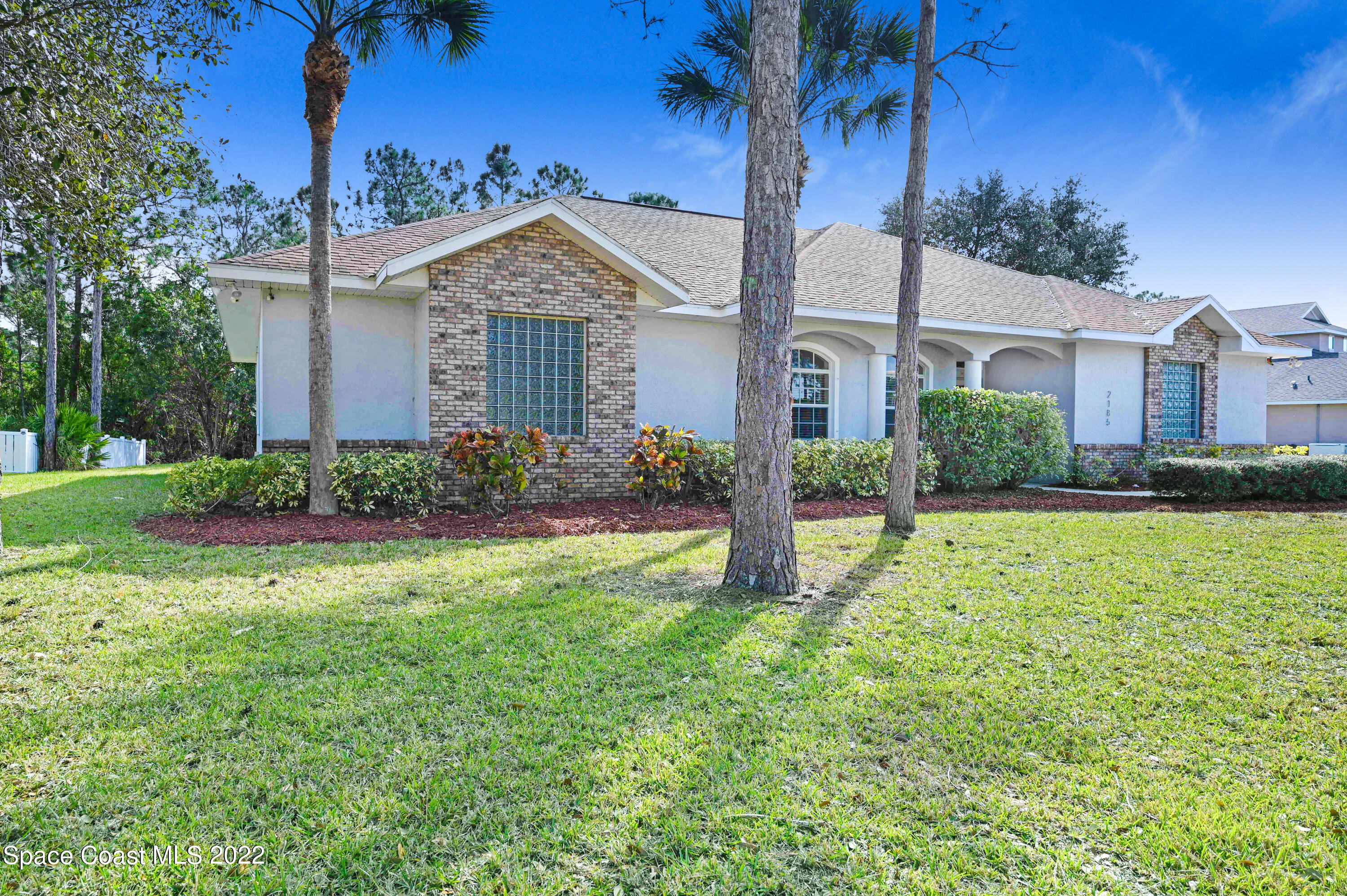 2185 Windbrook Drive Palm Bay, FL 32909 - Photo 13 of 61 a front view of a house with garden