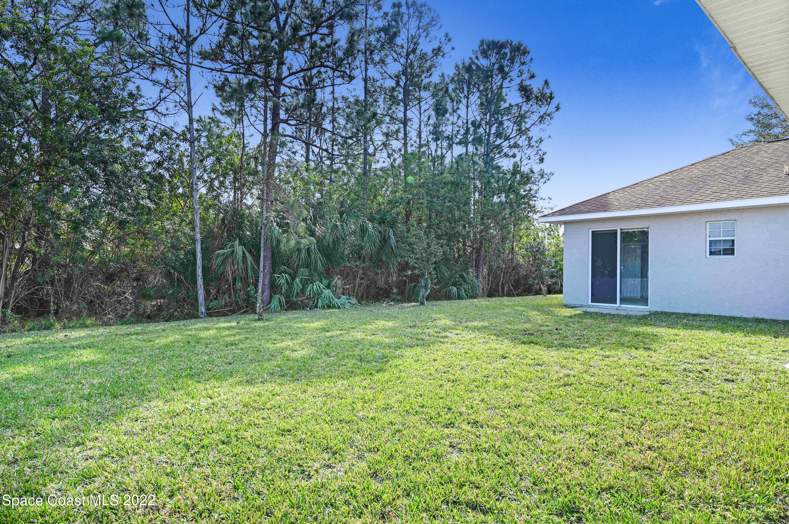 2185 Windbrook Drive Palm Bay, FL 32909 - Photo 14 of 61 a backyard of a house with lots of green space