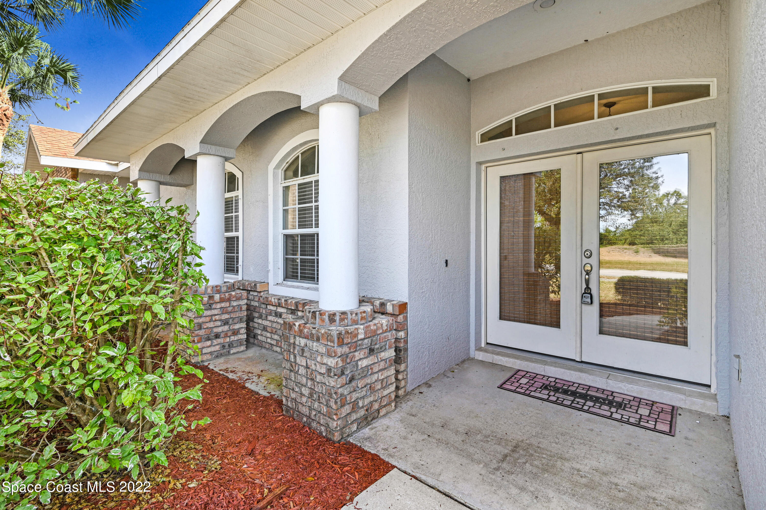 2185 Windbrook Drive Palm Bay, FL 32909 - Photo 18 of 61 a front view of a house with a garden