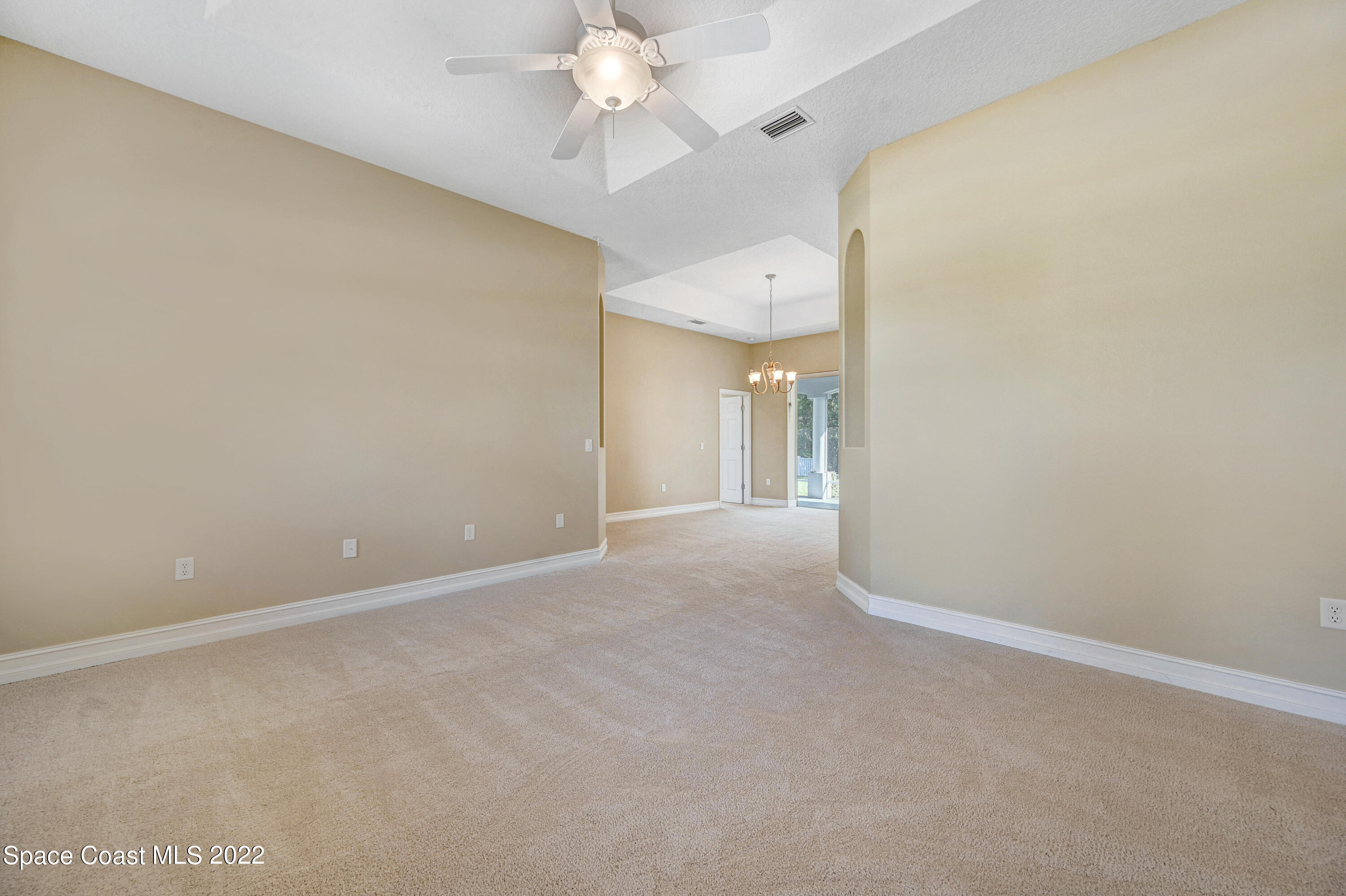 2185 Windbrook Drive Palm Bay, FL 32909 - Photo 26 of 61 a view of an empty room with a chandelier fan