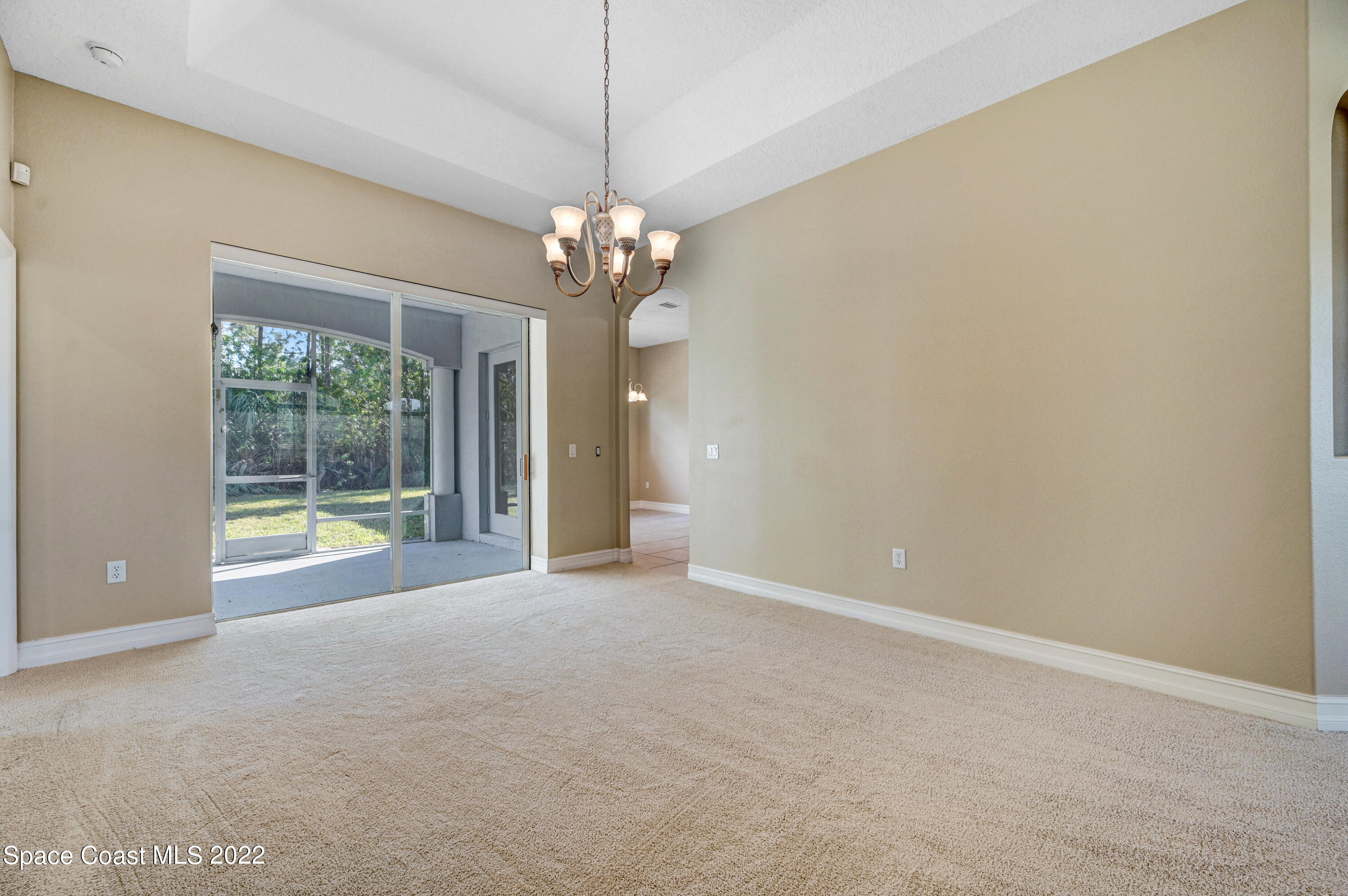 2185 Windbrook Drive Palm Bay, FL 32909 - Photo 30 of 61 a view of a livingroom with a chandelier fan and windows